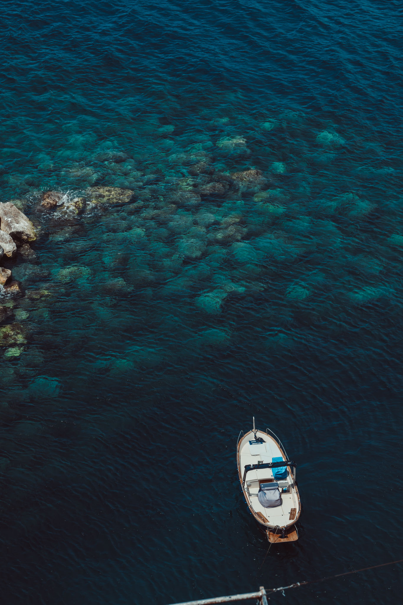 Sea blue waters with a boat, photo by Lucera Studio