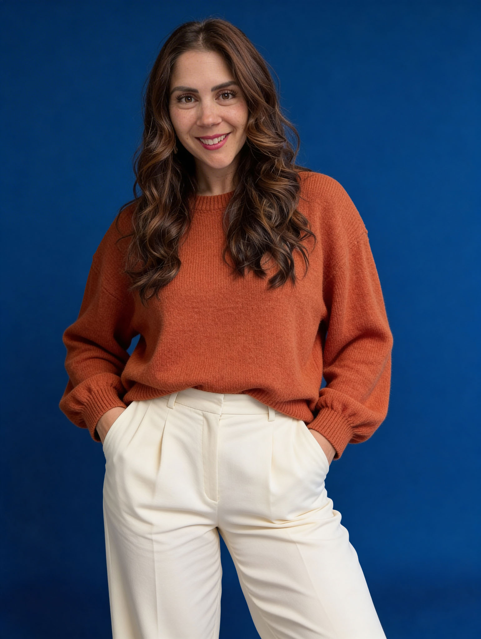 Liz McVoy, founder of Lucera Studio, standing in front of a blue backdrop.